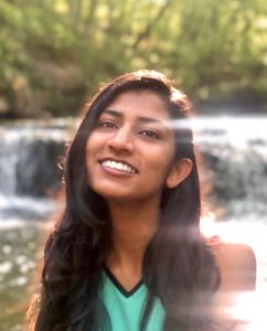 Image of Tara in front of a waterfall